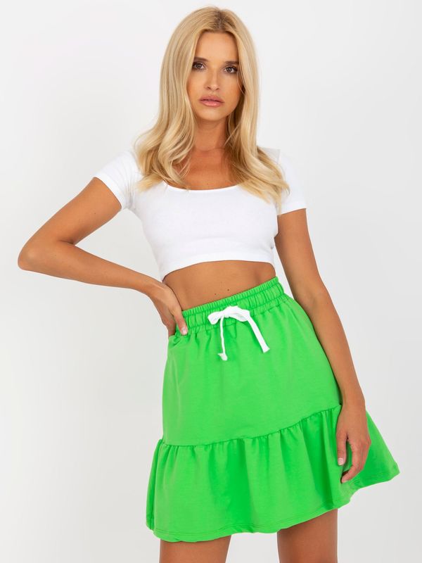 Fashionhunters Light green short sweatshirt skirt with tying detail