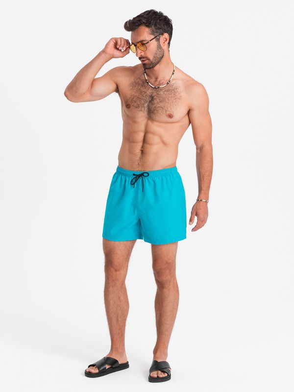 Ombre Ombre Neon men's swim shorts with magic print effect - turquoise
