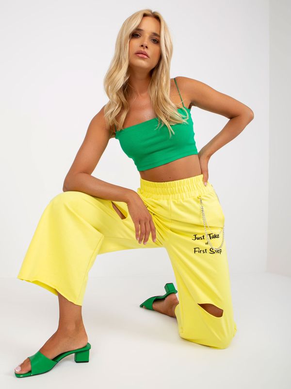 Fashionhunters Yellow wide sweatpants with inscriptions