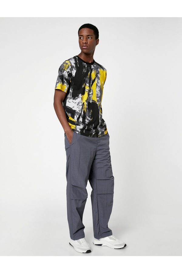 Koton Koton Parachute Trousers with a loose fit, lacing at the waist, and elasticated legs with a pocket detail.