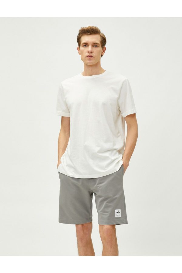 Koton Koton Shorts with a tie-waist Slim Fit Shorts with Pockets and Printed Labels.