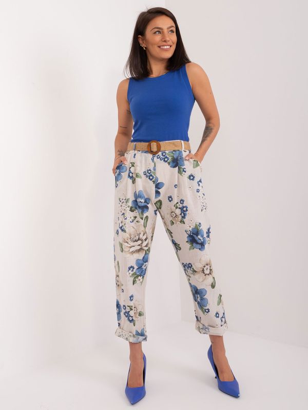 Fashionhunters Light beige fabric trousers with a floral print